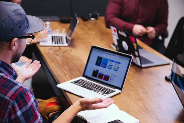 workers in an office at their laptops
