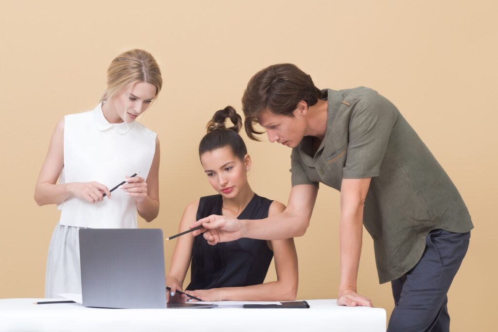 people giving feedback at a laptop